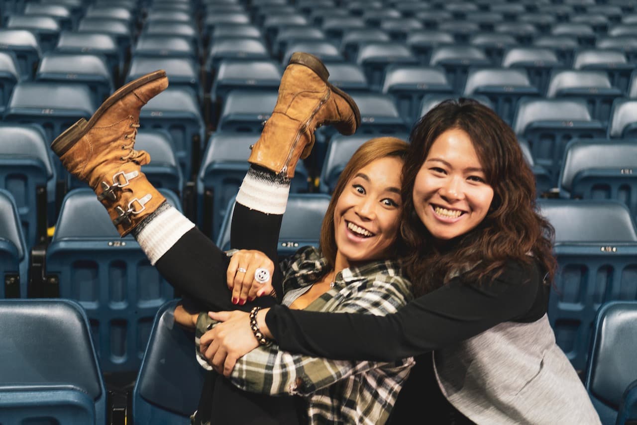 Fei Wu and Gasya Atherton playful moment in arena seats