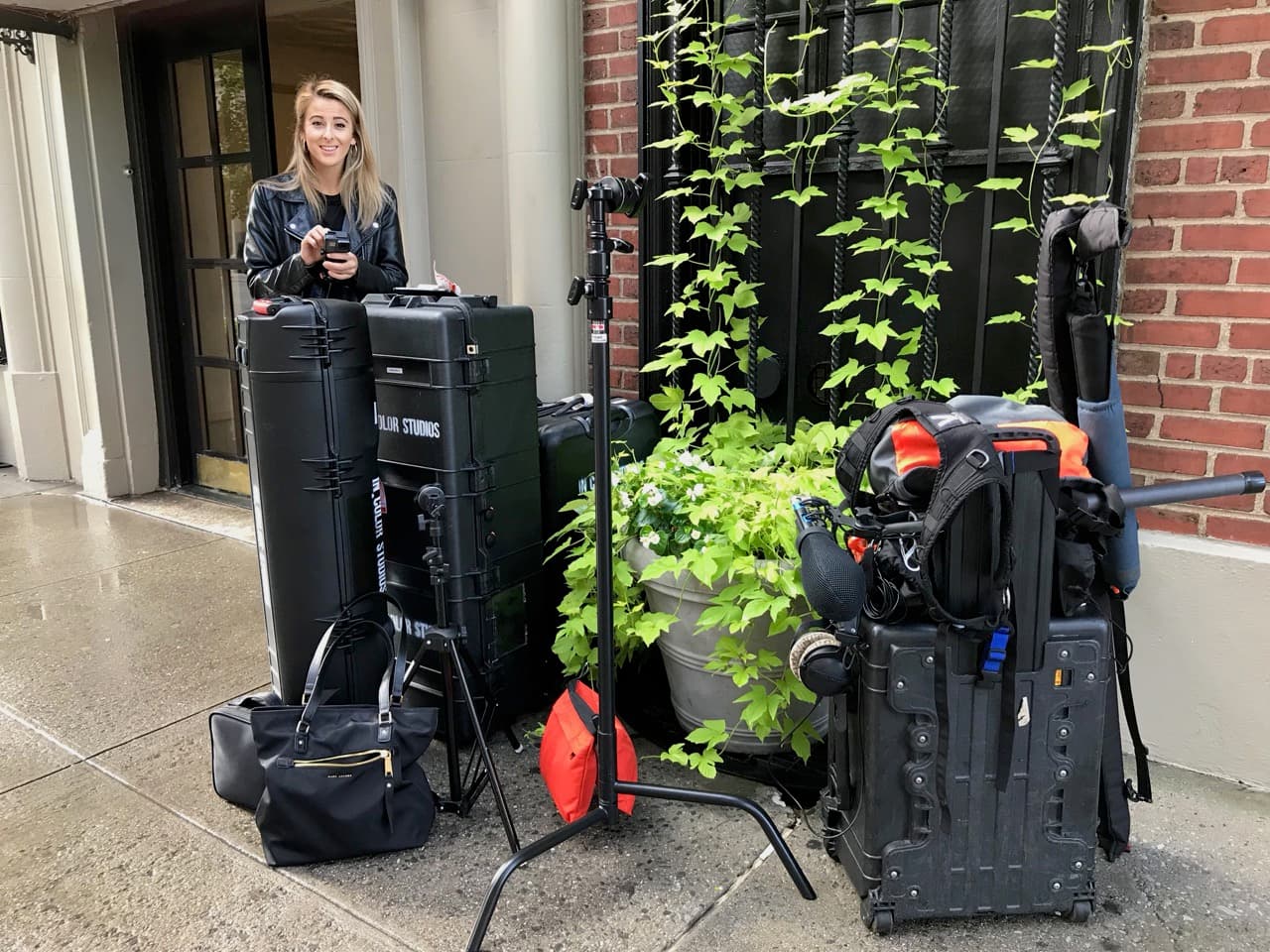 Production assistant with equipment cases ready for location shoot