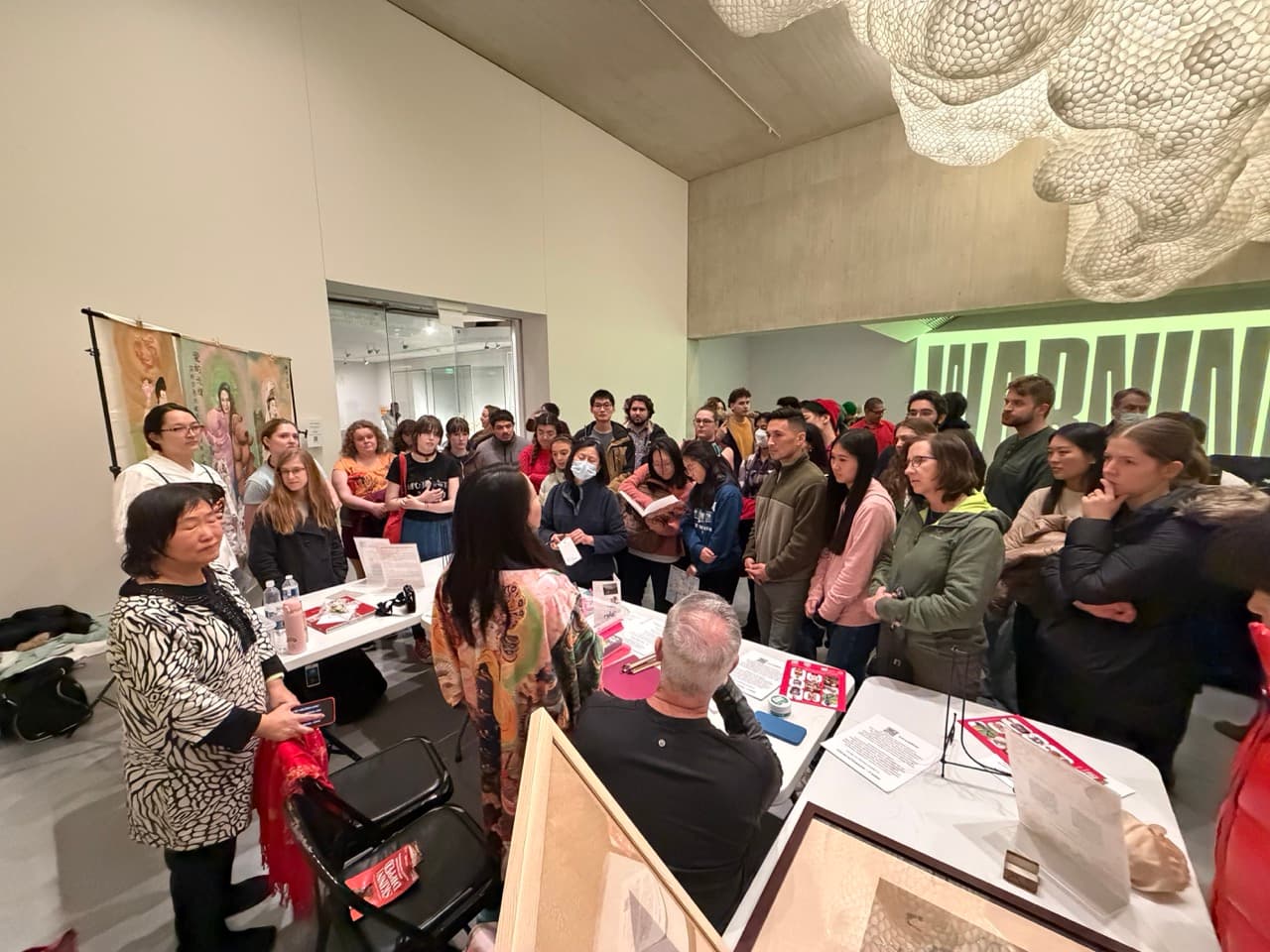 Fei Wu and Xiang Li presenting to a large crowd at Museum of Fine Arts Boston