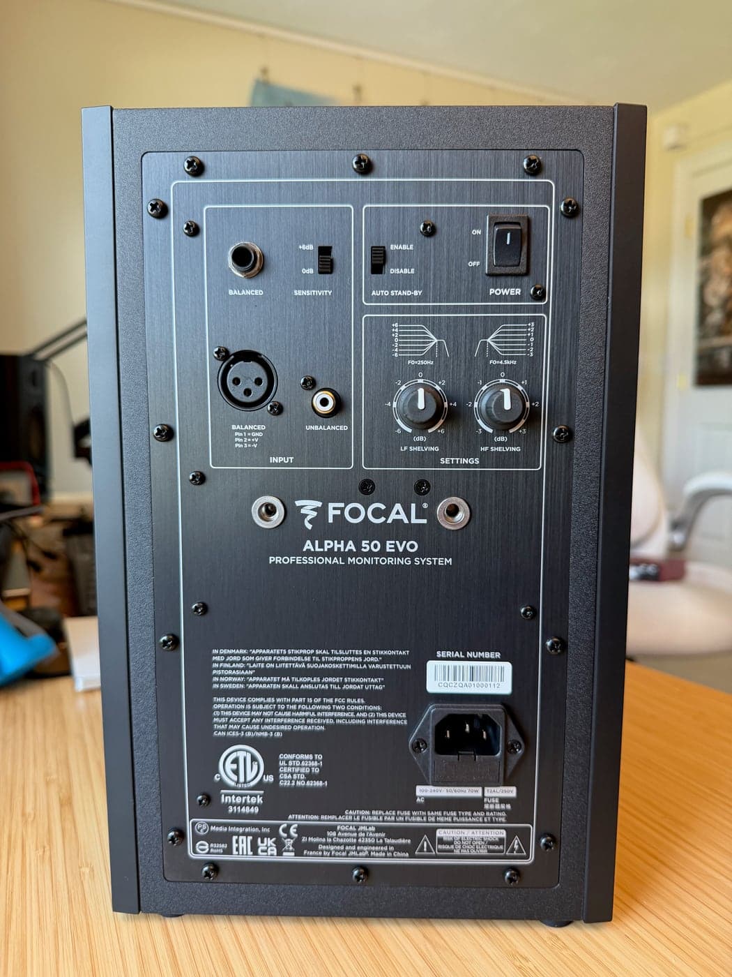 Close-up of the Focal Alpha 50 Evo rear panel with XLR, TRS, RCA, sensitivity, bass, treble, and standby controls