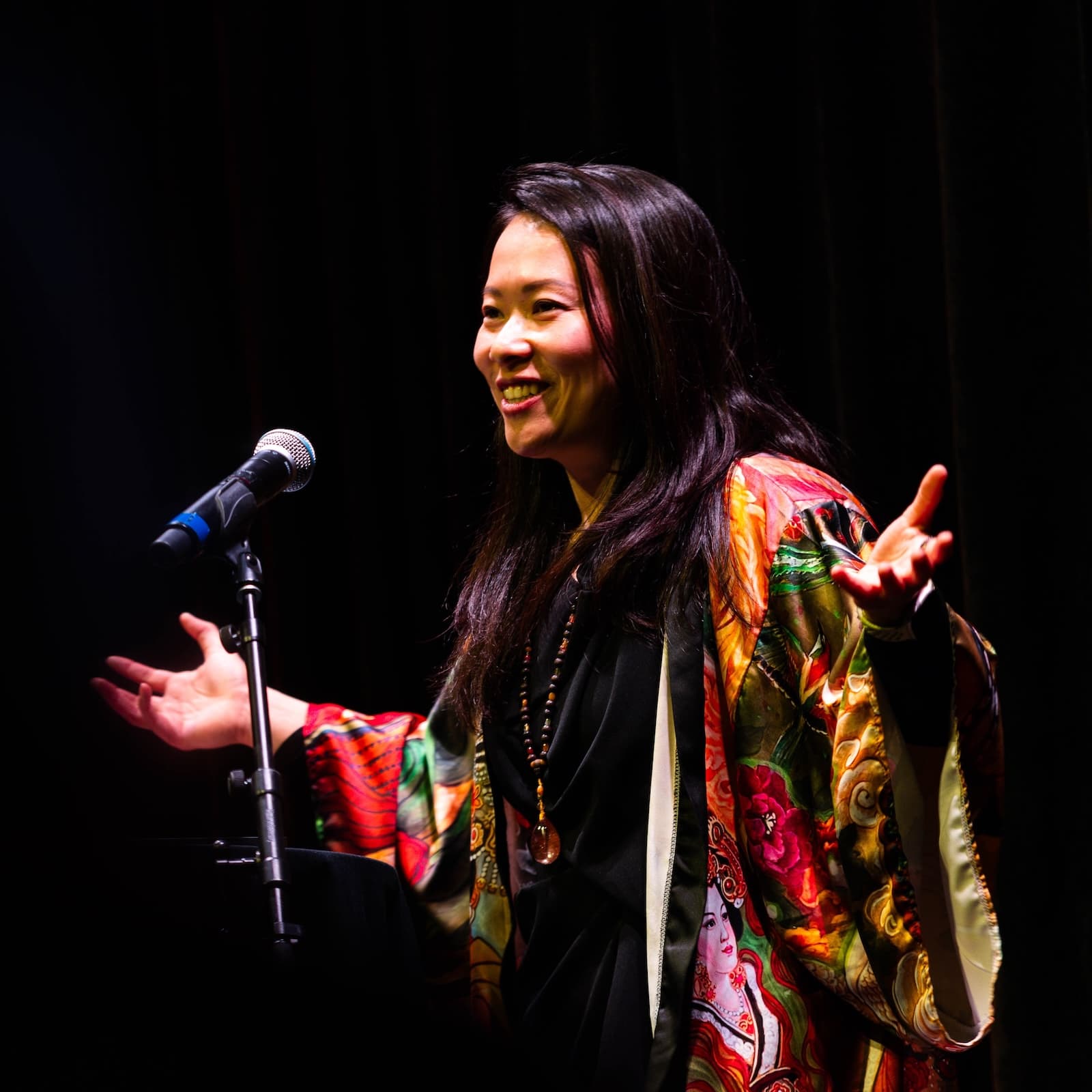 Fei Wu speaking on stage